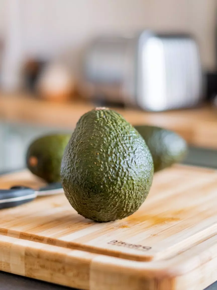 A Photo Of A Whole Avocado Fruit On A Wo Ltciskntquwpdjbiwdjvba U4fc3 Mxskskovwil80tfg