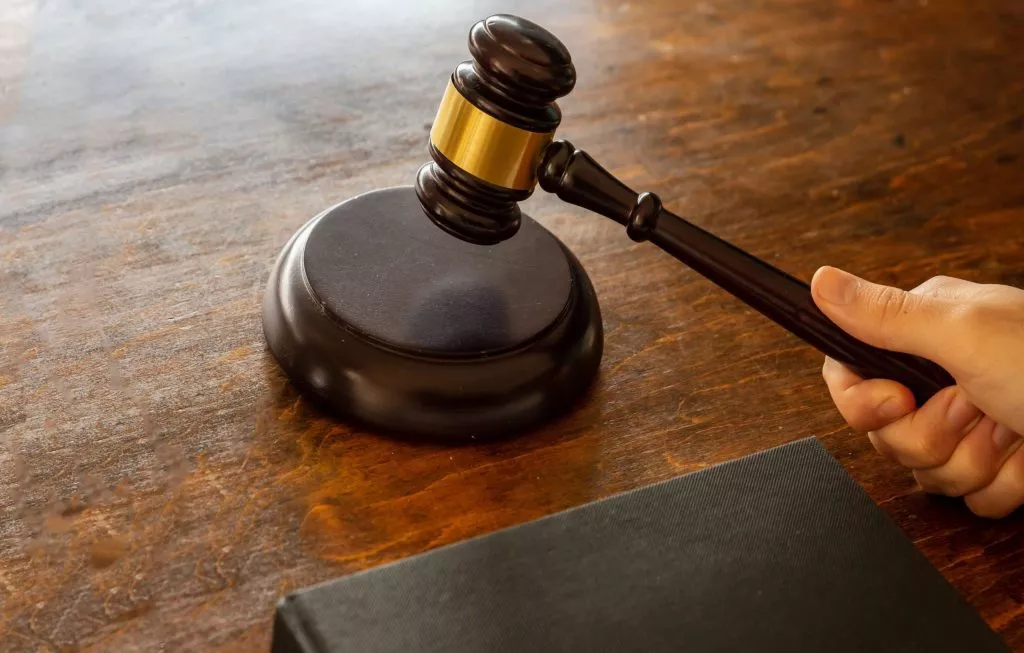 Judge Hitting A Gavel On Wooden Desk Background Bcaalmf Min 2 Scaled 1